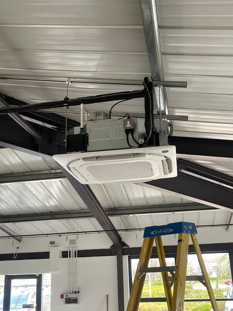 Ceiling cassette air conditioner fixed to the steel frame of a commercial unit