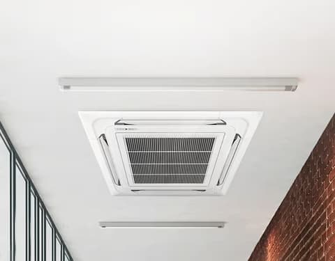 Close-up of a white four-way ceiling cassette air conditioning panel