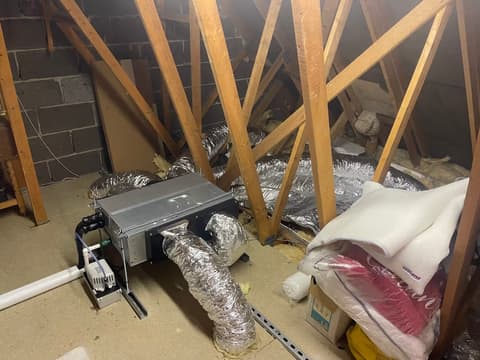 Concealed ducted air conditioning unit with insulated flexible ductwork in a loft space