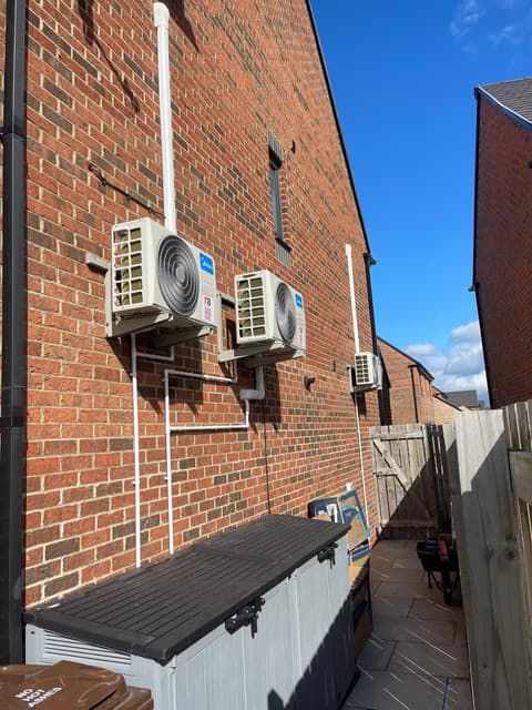 Multi-split air conditioning outdoor units installed on the side wall of a new-build house
