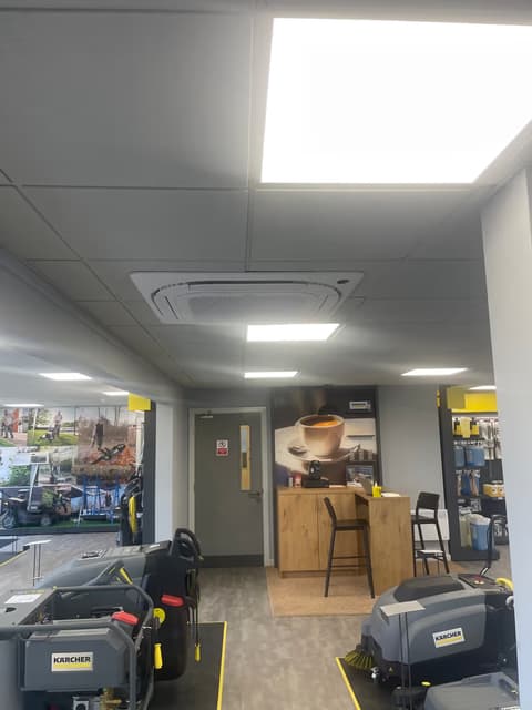 Four-way ceiling cassette air conditioning unit in the suspended ceiling of an office reception
